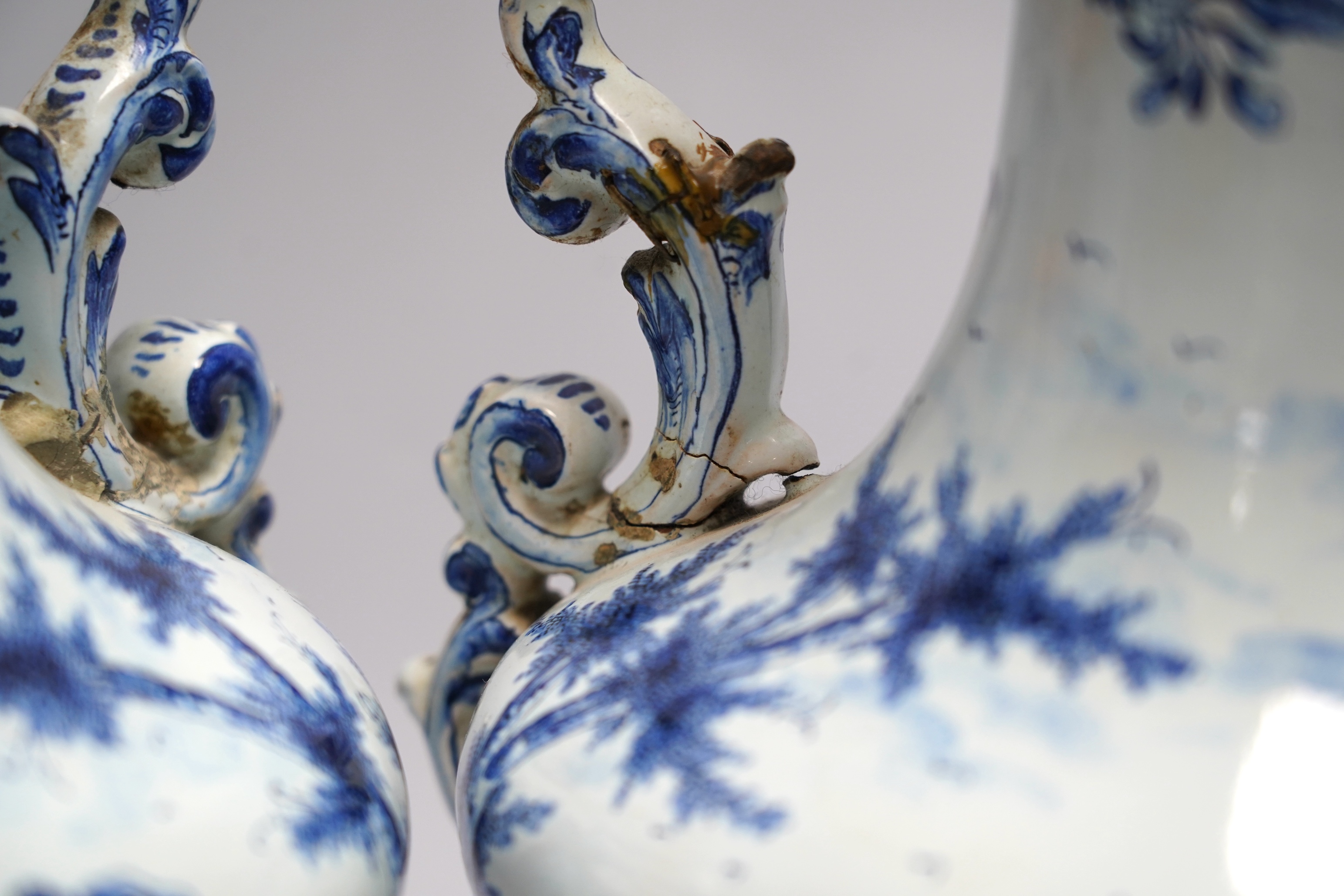 A pair of 19th century Delft blue and white vases, 35cm high. Condition - poor